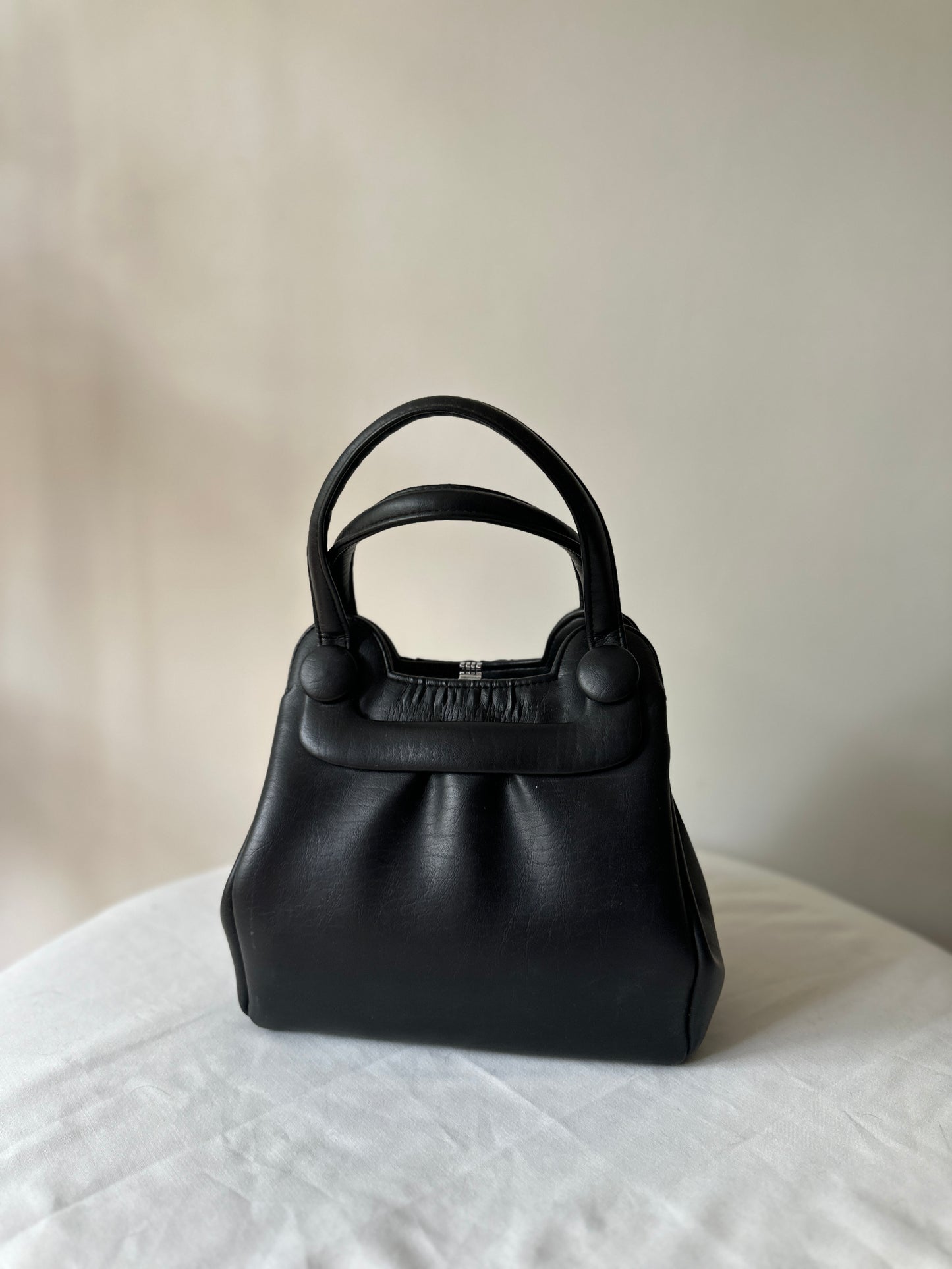 black vinyl handbag