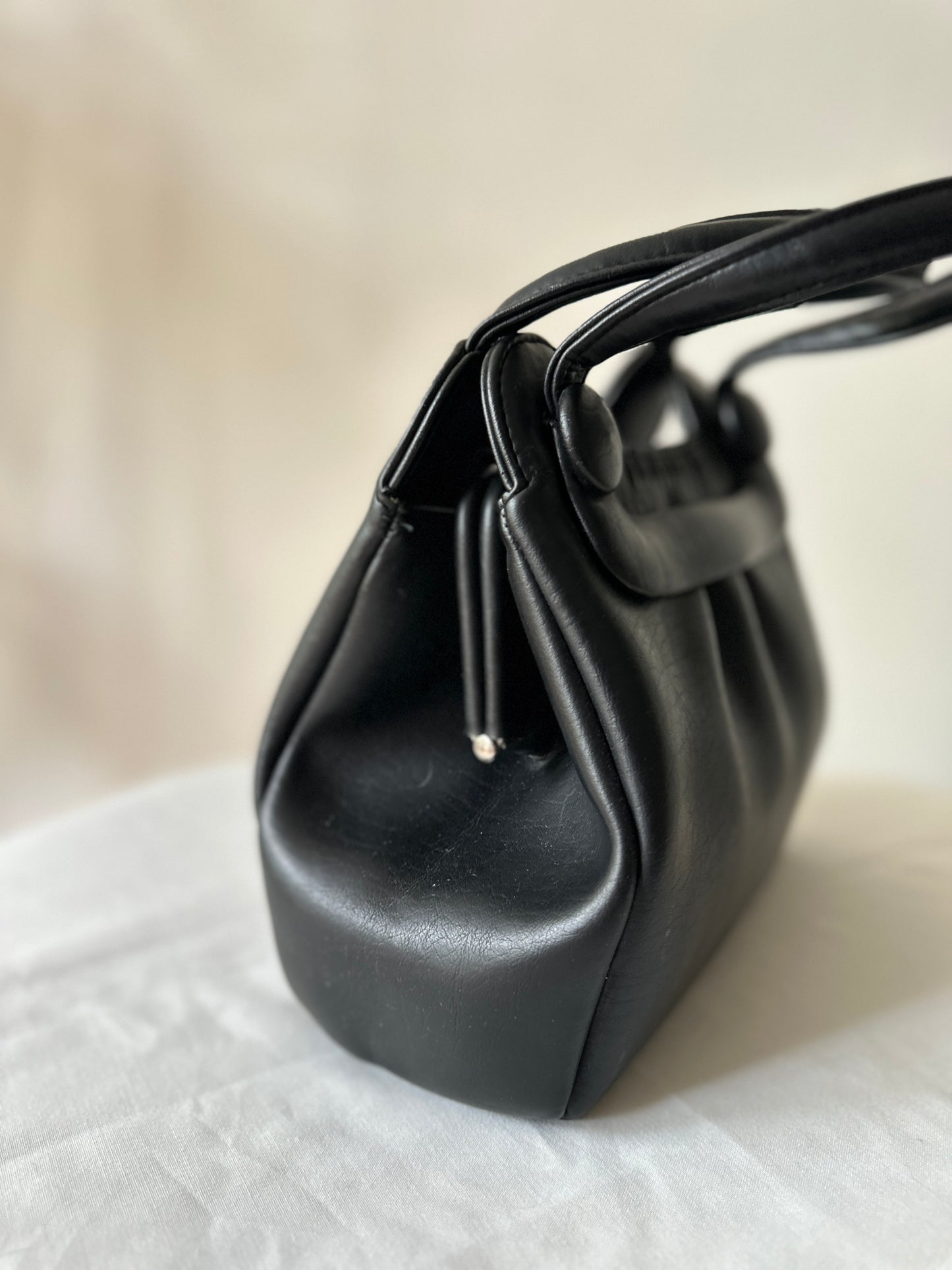 black vinyl handbag
