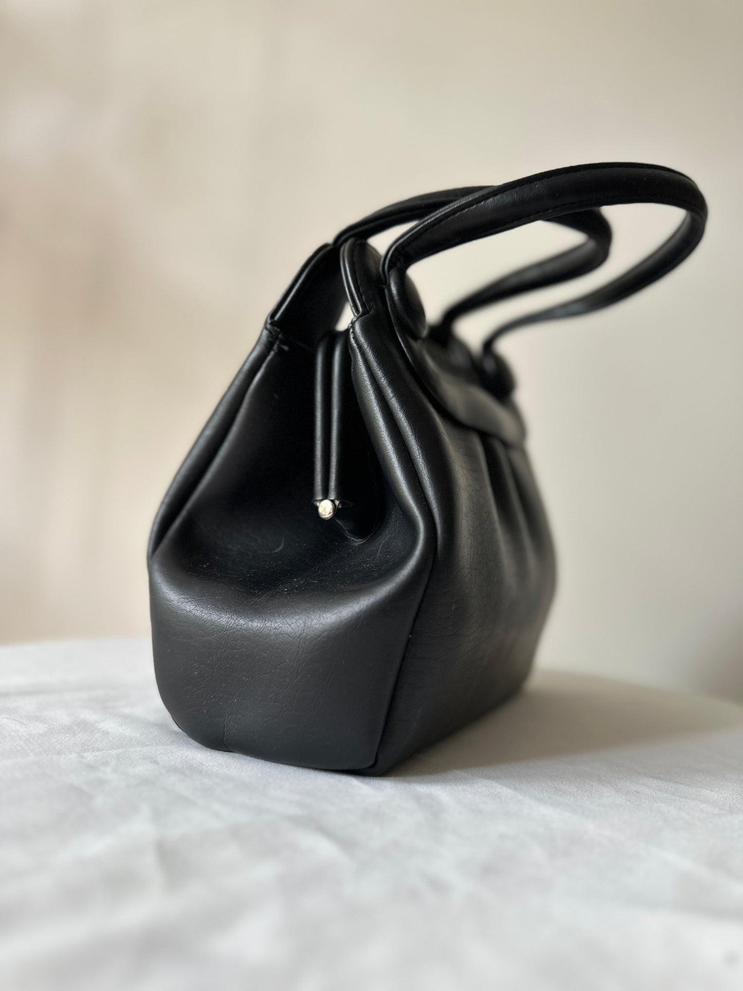 black vinyl handbag