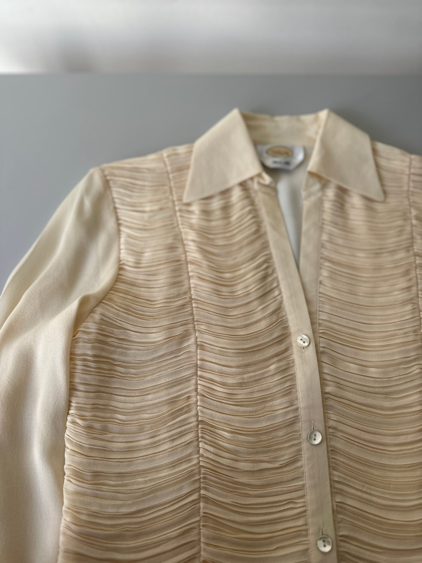 cream ruffled blouse