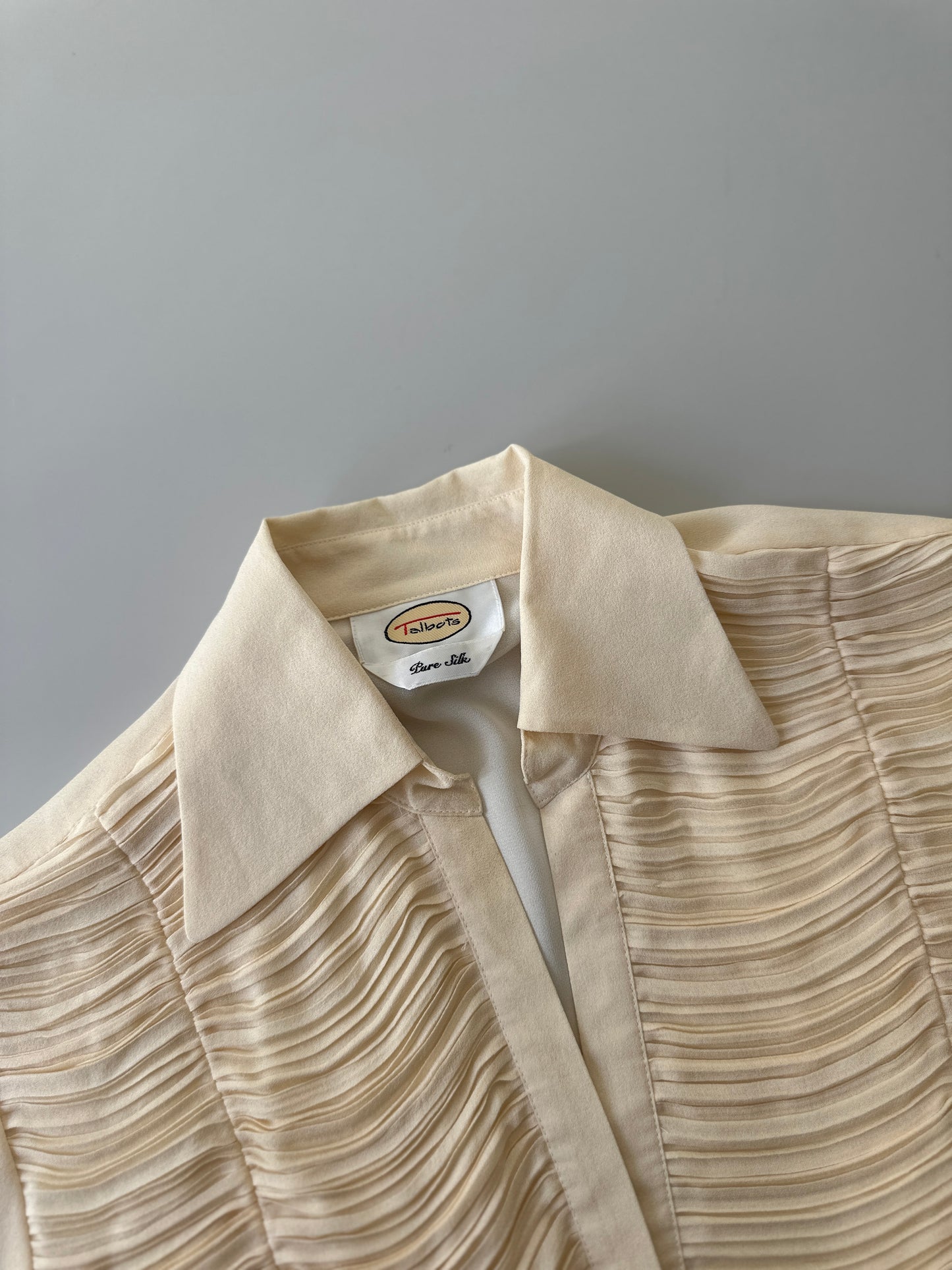 cream ruffled blouse