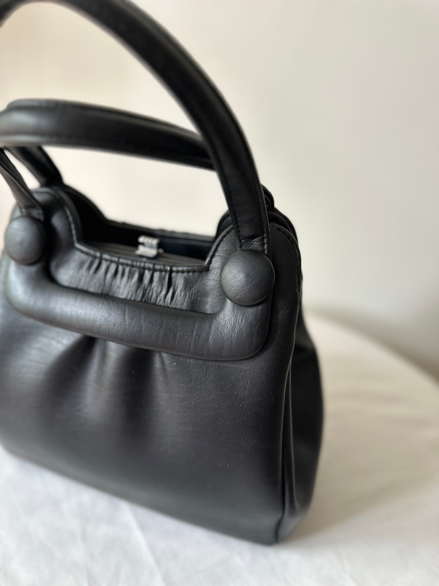 black vinyl handbag