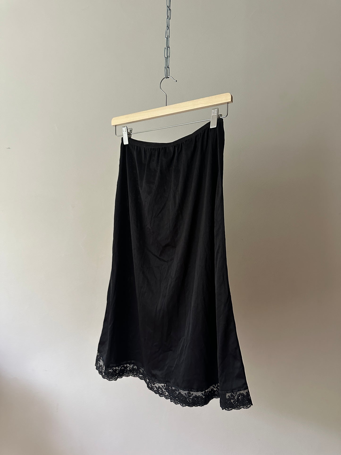 black mid-length slip skirt