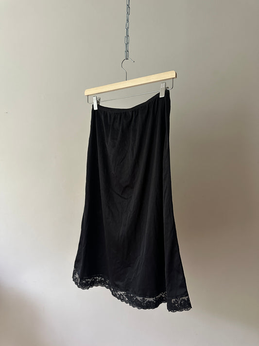 black mid-length slip skirt