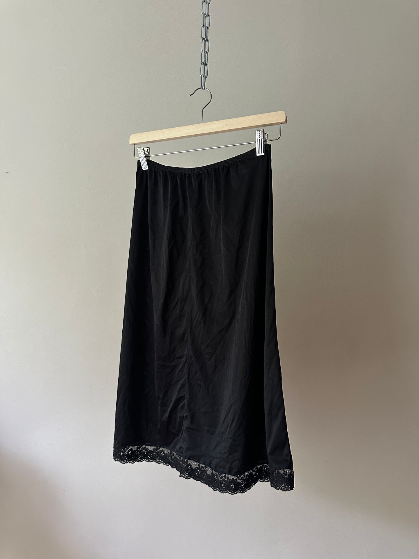 black mid-length slip skirt