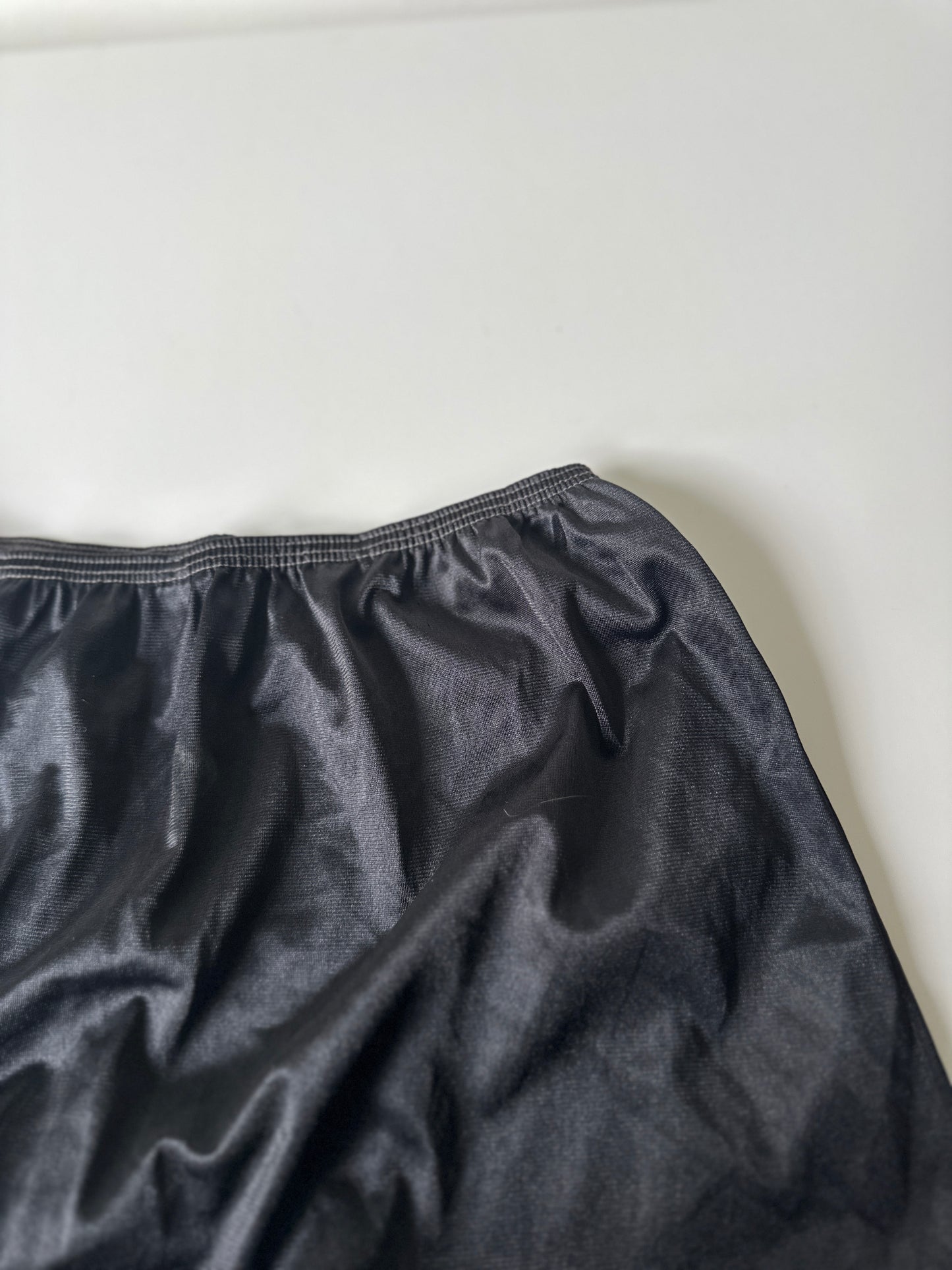 black mid-length slip skirt