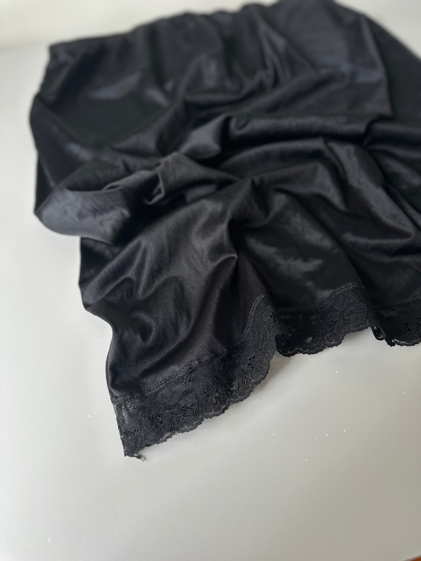 black mid-length slip skirt