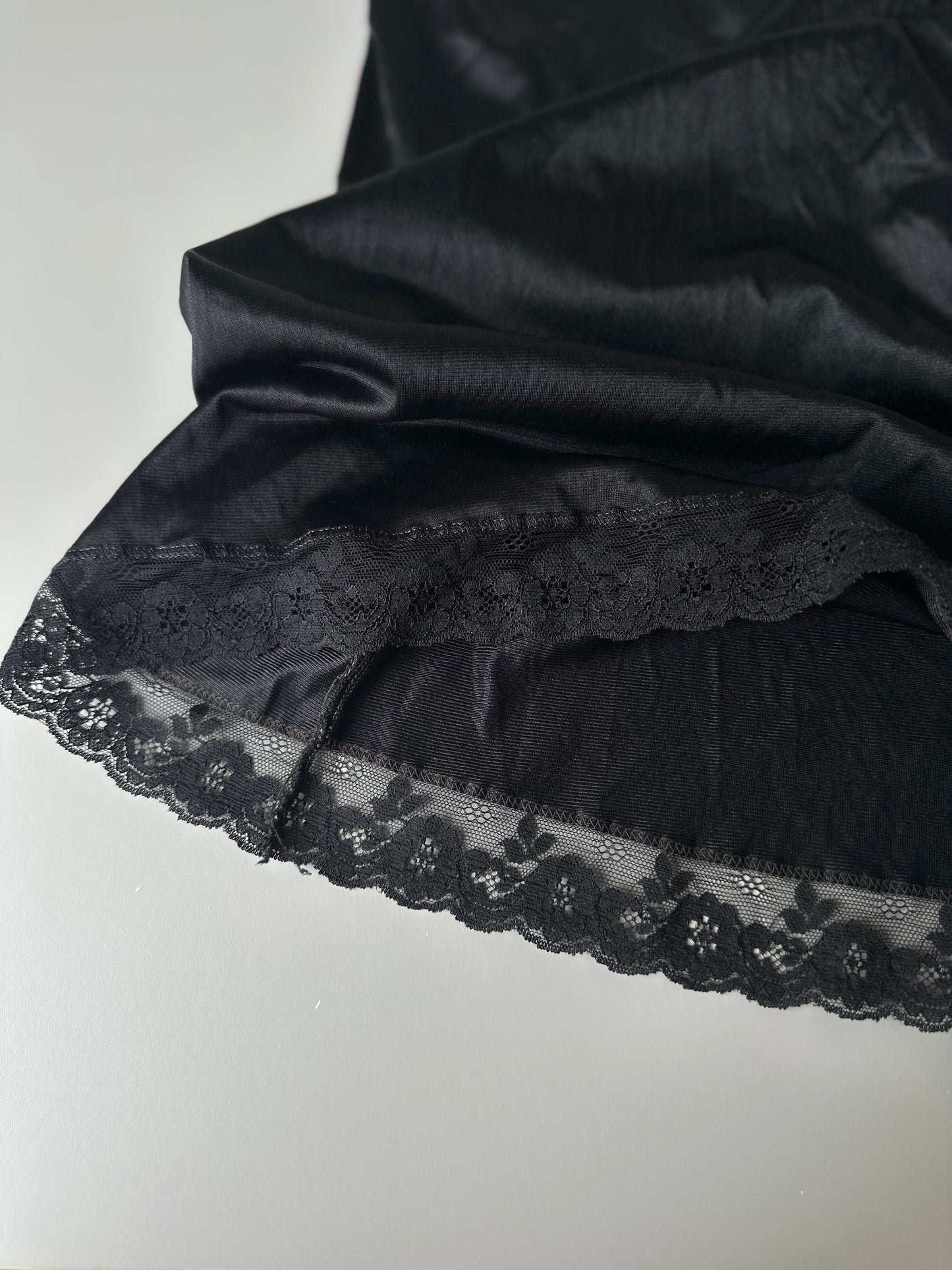 black mid-length slip skirt