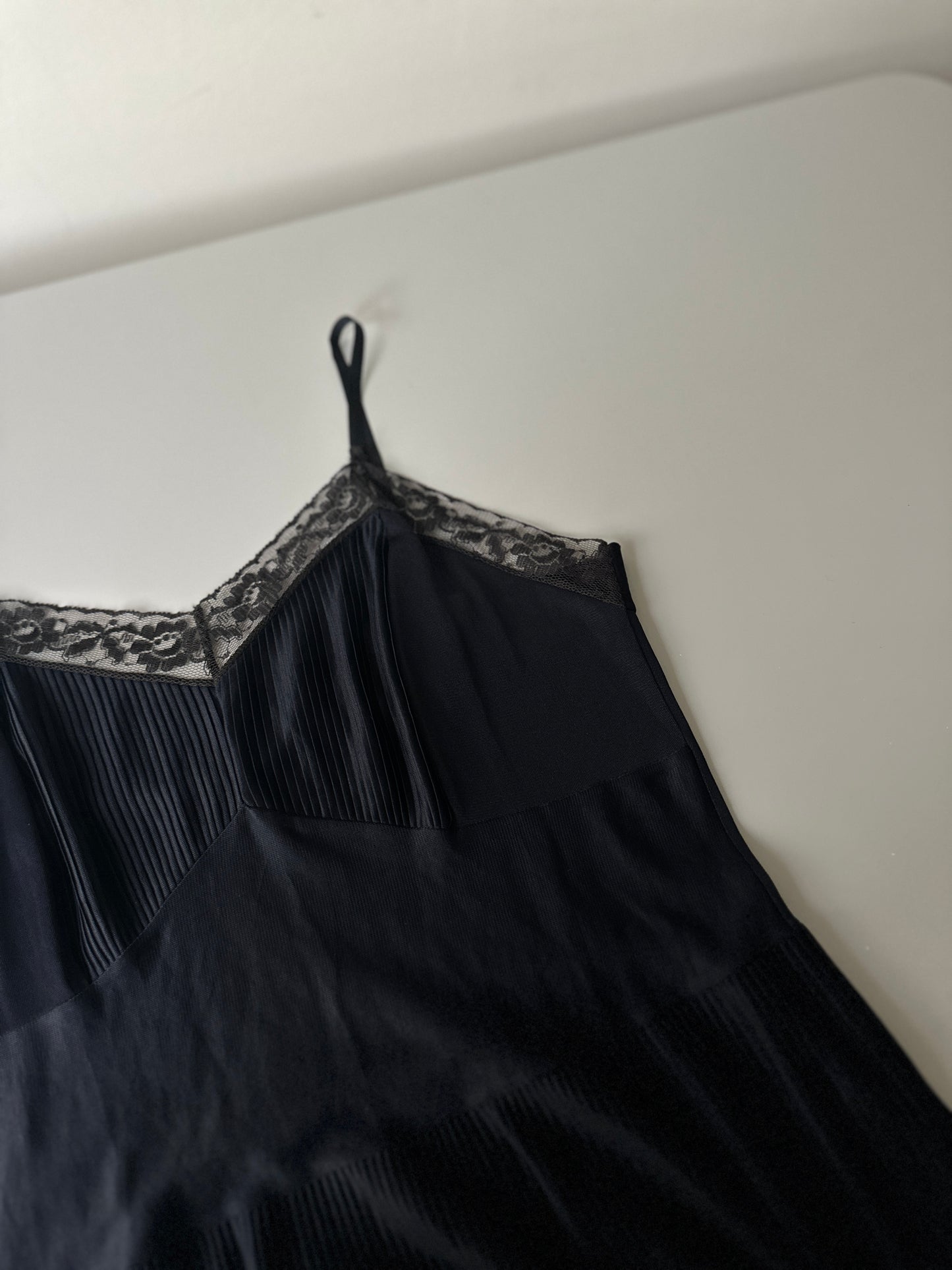 black pleated mid-length slip