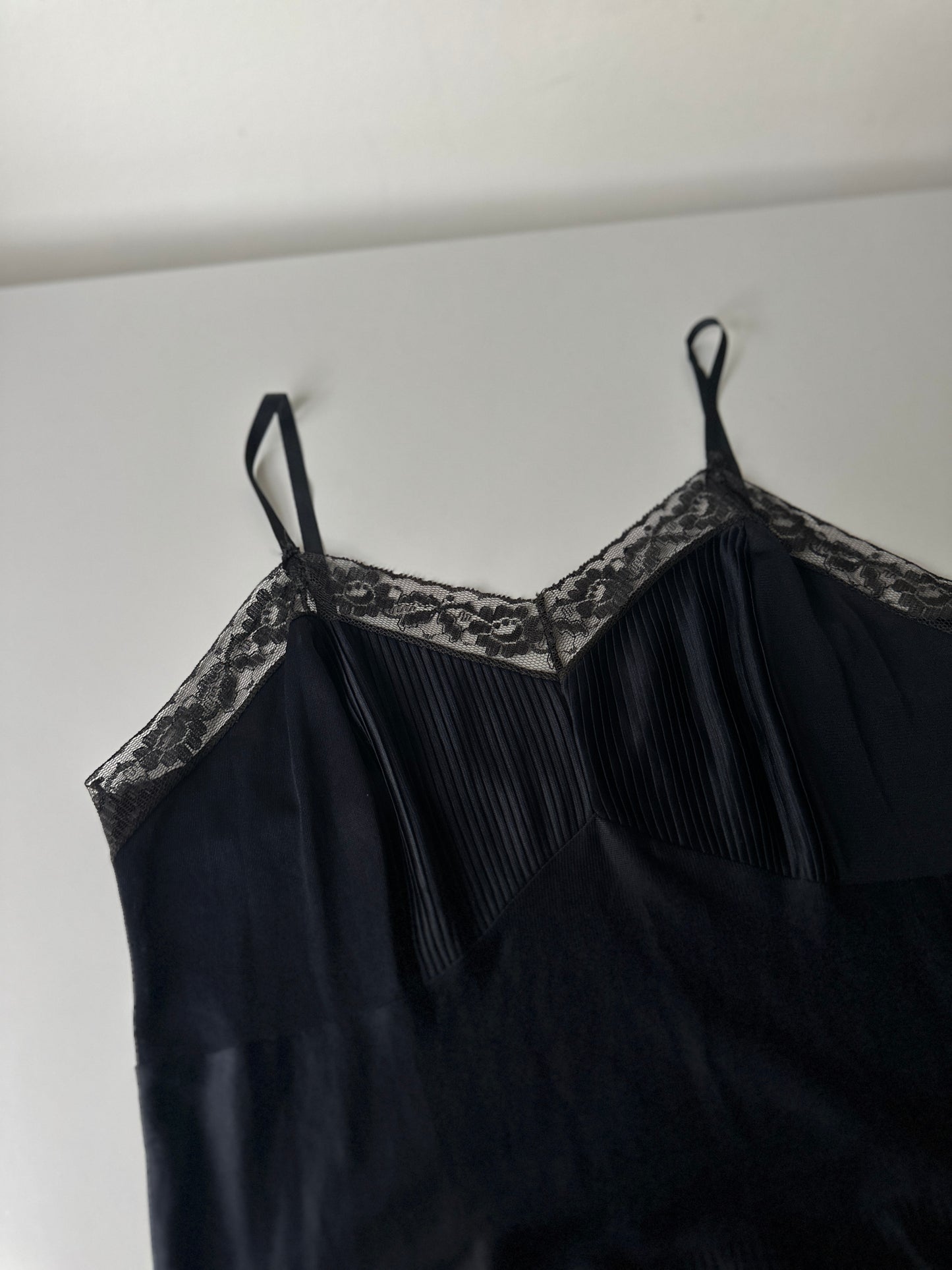black pleated mid-length slip