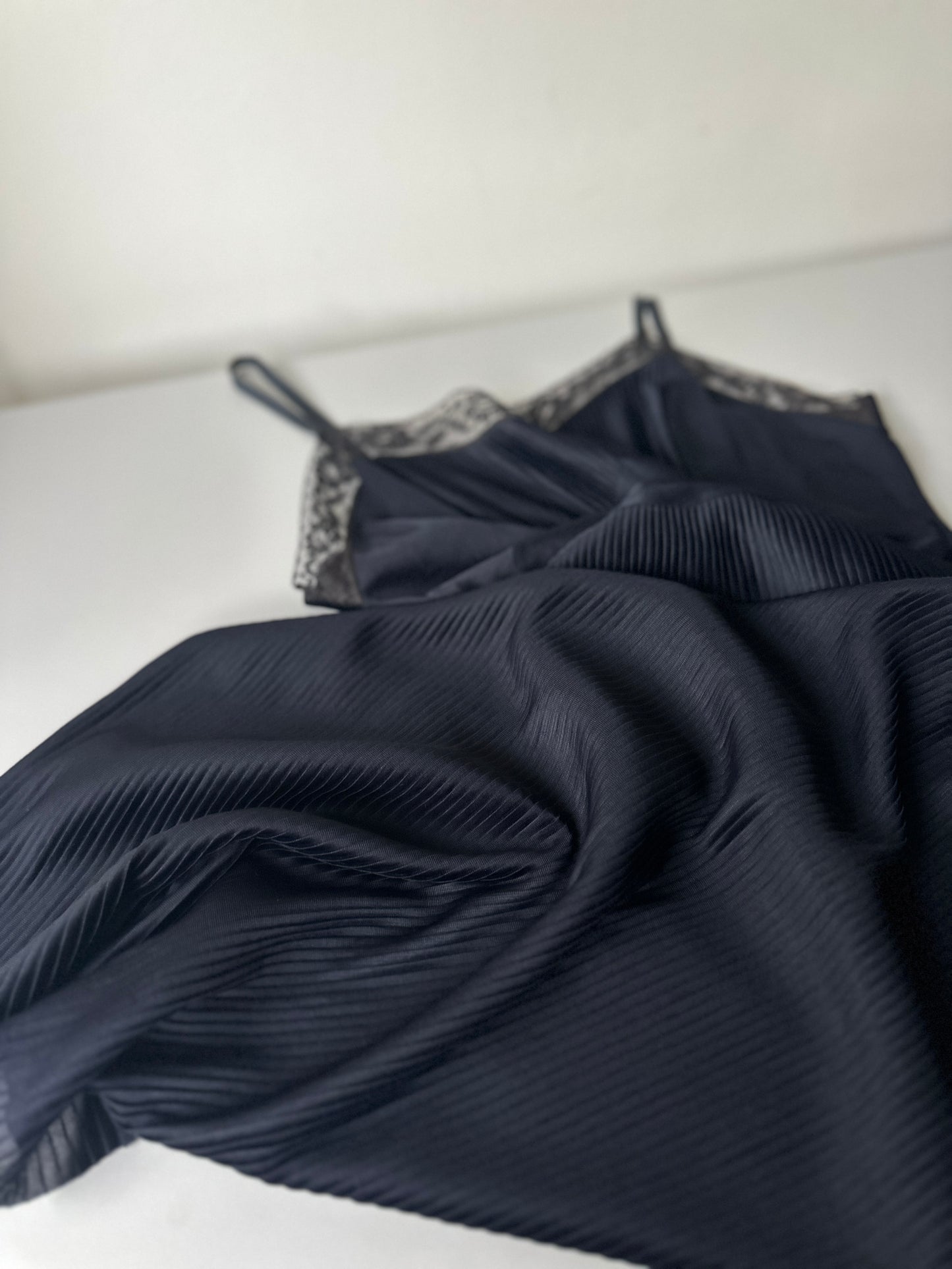 black pleated mid-length slip